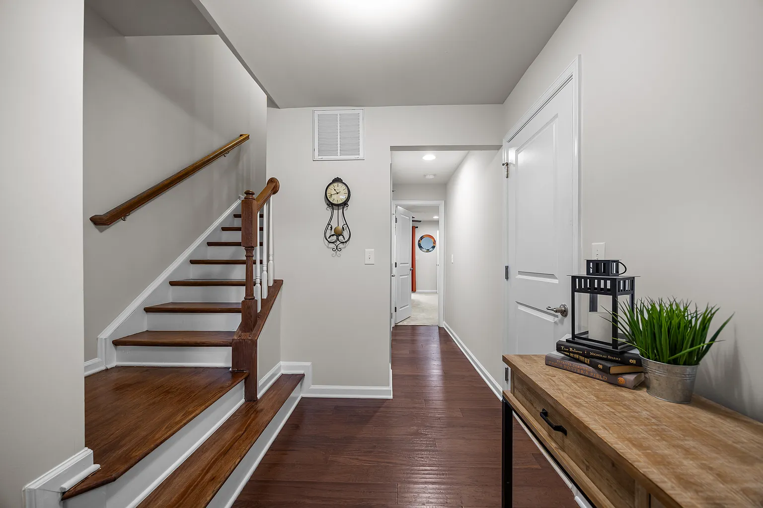 Elegant foyer with rich hardwood and staircase details