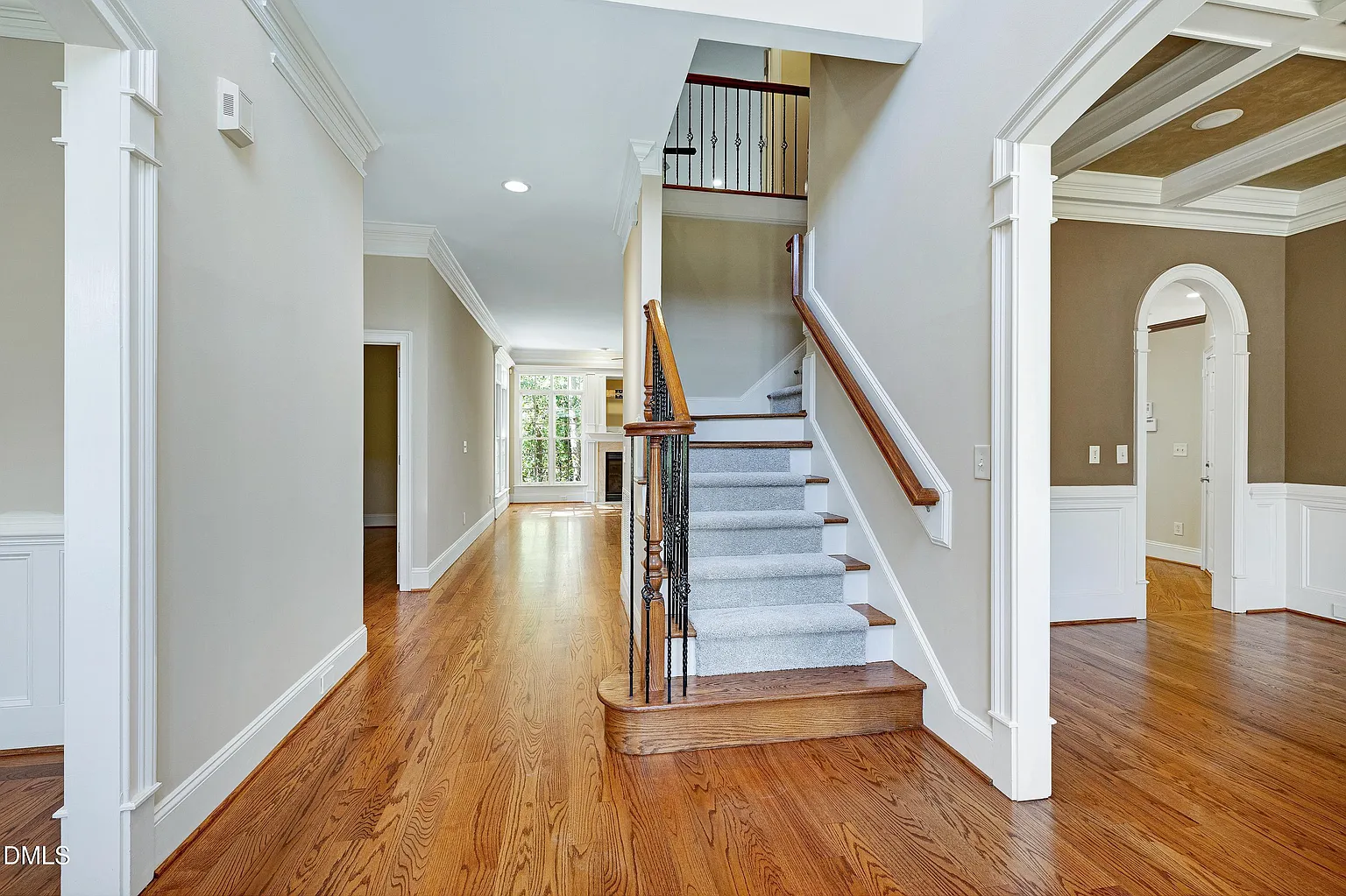 Grand foyer with curved staircase and hardwood floors