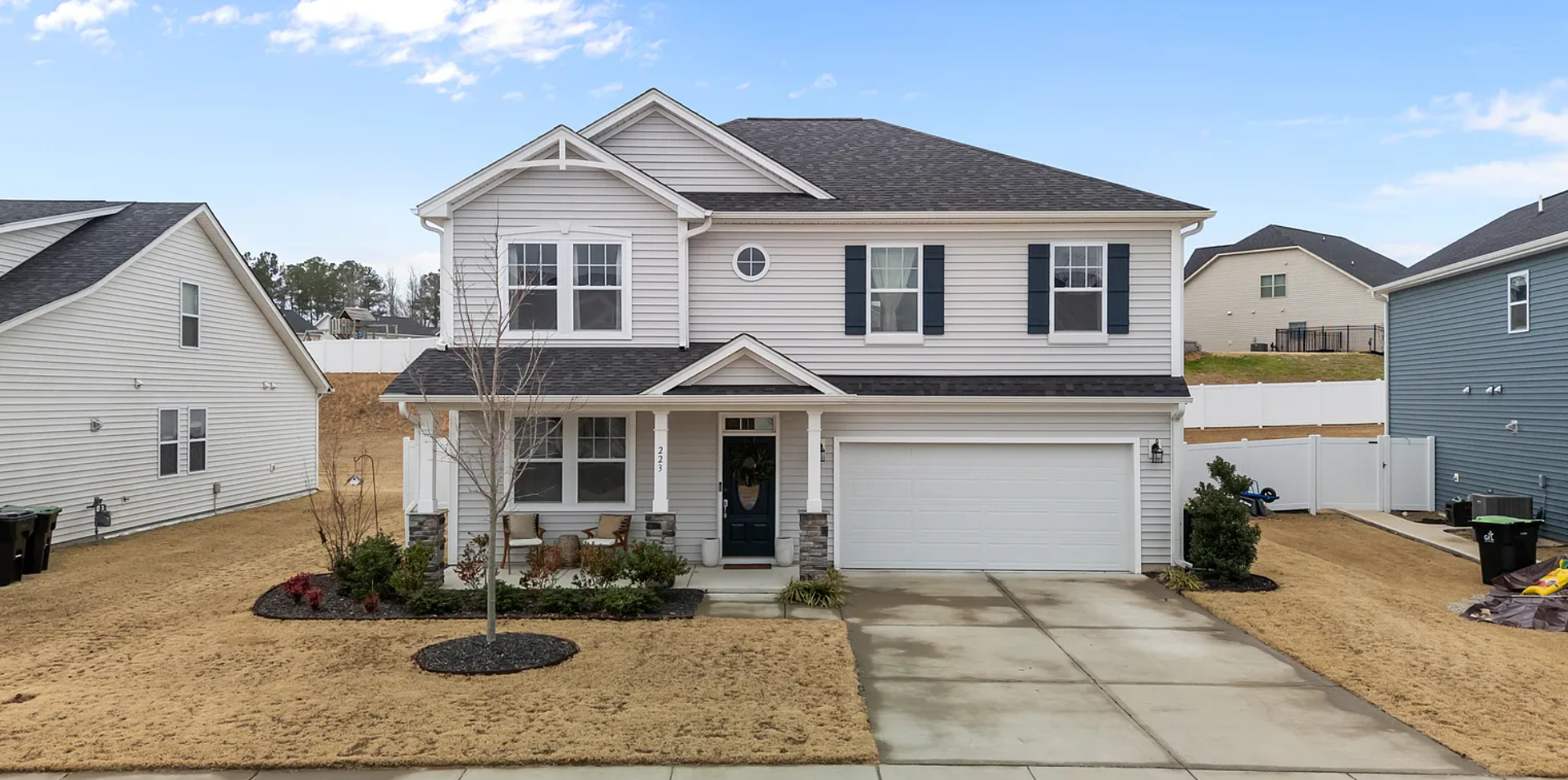 Modern two-story home with pristine landscaping and stonework