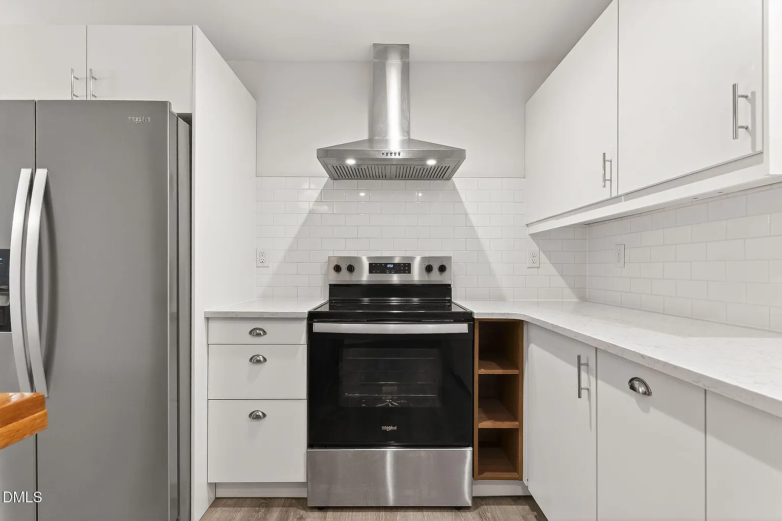 Sophisticated kitchen showcasing white cabinetry and subway tile